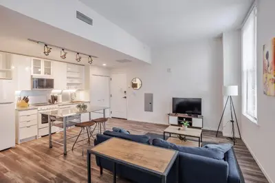 a living room with a couch and a table at CozySuites at Sky Central in Cincinnati