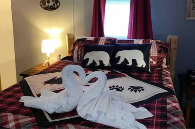 two swans making a heart on a bed at 2 Bedroom Logan Ohio Hot Tub in Logan