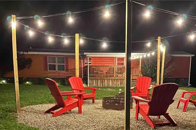 a group of chairs sitting under a tent with lights at 2 Bedroom Logan Ohio Hot Tub in Logan