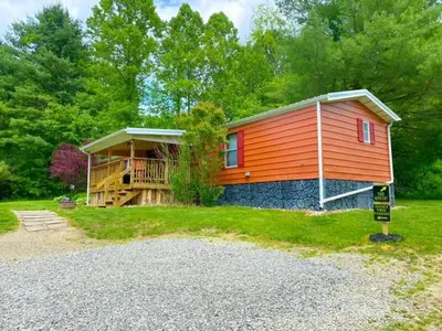 a small cabin in the middle of a forest at 2 Bedroom Logan Ohio Hot Tub in Logan