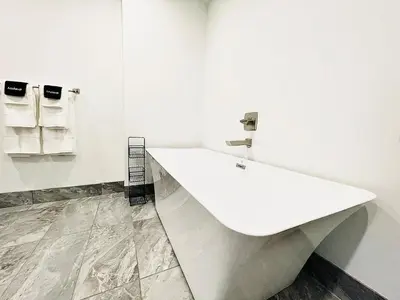 a white bathroom with a large white tub at The 419 Ten-Room Boutique in Sandusky in Sandusky