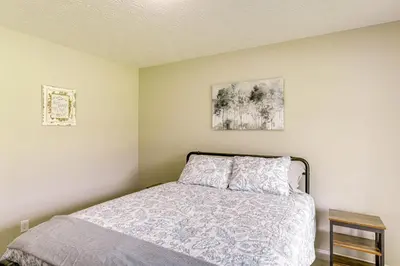 a bedroom with a bed and two pictures on the wall at Deck and Outdoor Dining Family Getaway in Dry Ridge in Dry Ridge