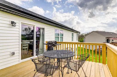 a patio with a table and chairs on a deck at Deck and Outdoor Dining Family Getaway in Dry Ridge in Dry Ridge