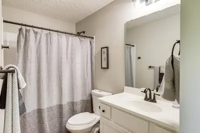 a bathroom with a white toilet and a sink at Deck and Outdoor Dining Family Getaway in Dry Ridge in Dry Ridge