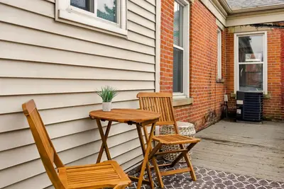 two chairs and a wooden table on a patio at Walk to OSU & Short North FREE PARKING Fire Pit in Columbus