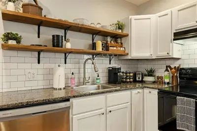 a kitchen with white cabinets and a sink at Walk to OSU & Short North FREE PARKING Fire Pit in Columbus