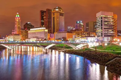 a city skyline with a bridge over a river at Walk to OSU & Short North FREE PARKING Fire Pit in Columbus