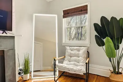a mirror in a room with a chair and a mirror at Walk to OSU & Short North FREE PARKING Fire Pit in Columbus