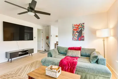 a living room with a couch and a flat screen tv at 3 Mi to Downtown Youngstown Apt with Deck! in Youngstown