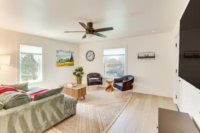 a living room with a couch and a ceiling fan at 3 Mi to Downtown Youngstown Apt with Deck! in Youngstown