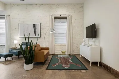 a living room with a couch and a tv at Modern Loft-Style Retreat Near Blenko Glass in Milton, WV in Hurricane