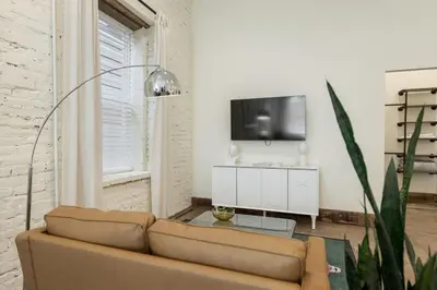 a living room with a couch and a tv at Modern Loft-Style Retreat Near Blenko Glass in Milton, WV in Hurricane
