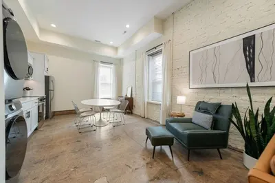 a living room with a couch and a table at Modern Loft-Style Retreat Near Blenko Glass in Milton, WV in Hurricane
