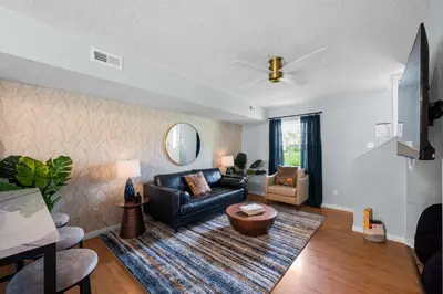 a living room with a couch and a table at 4 apartments 10 bedrooms - 2 and a half Miles from Ark in Williamstown