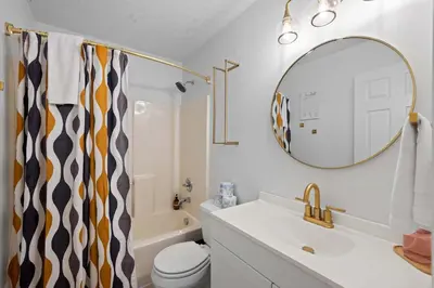 a bathroom with a sink and a mirror and a toilet at 4 apartments 10 bedrooms - 2 and a half Miles from Ark in Williamstown