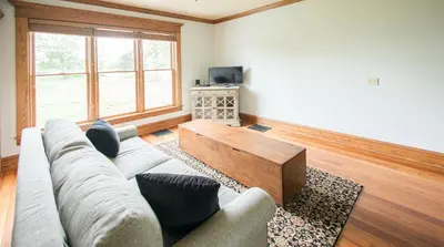 a living room with a couch and a coffee table at Nature Valley Farm- 2BD/1BA on private 53 acres in North Lawrence