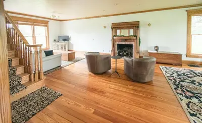 a living room with a couch and a fireplace at Nature Valley Farm- 2BD/1BA on private 53 acres in North Lawrence
