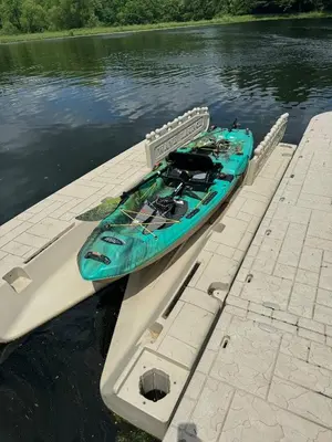 a blue kayak tied to a dock in the water at Nature Valley Farm- 2BD/1BA on private 53 acres in North Lawrence