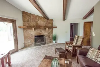 a large living room with a stone fireplace at Sherwood Forest Park- 6BD/3BA on Private Ohio Land in North Lawrence