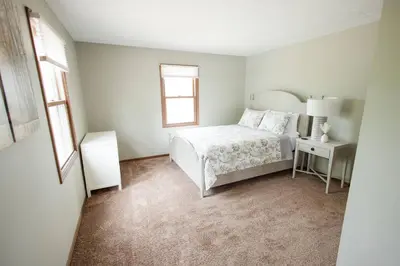a white bedroom with a bed and a window at Sherwood Forest Park- 6BD/3BA on Private Ohio Land in North Lawrence
