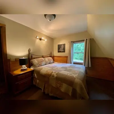 a bedroom with a bed and a window at A-Frame #01 - by The Chalets in Logan