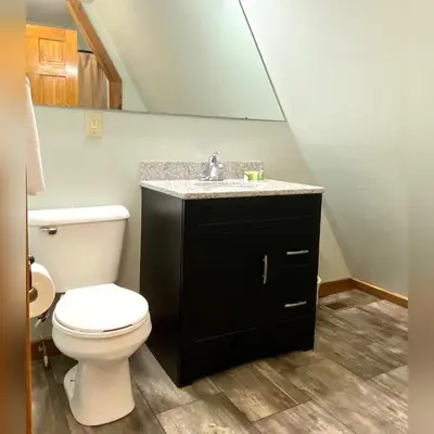 a bathroom with a toilet and a sink at A-Frame #01 - by The Chalets in Logan