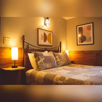 a bedroom with a bed with a lamp on it at A-Frame #02 - by The Chalets in Logan