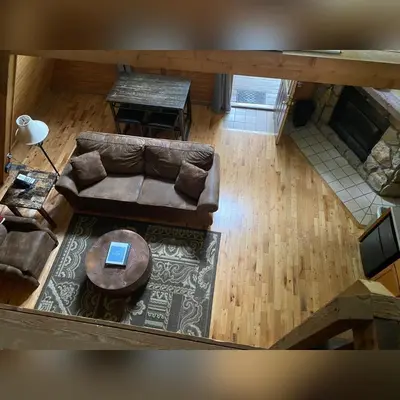an overhead view of a living room with a couch and a table at A-Frame #02 - by The Chalets in Logan