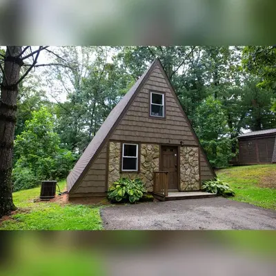 a small house with a gambrel roof at A-Frame #04 - by The Chalets in Logan