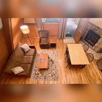 a living room with a couch and a table at A-Frame #07 - by The Chalets in Logan