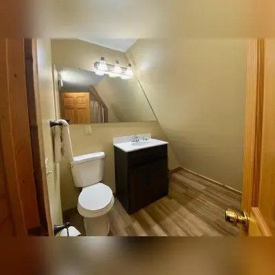 a small bathroom with a toilet and a sink at A-Frame #08 - by The Chalets in Logan