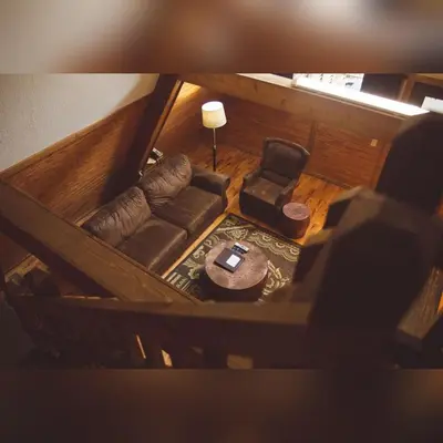 an overhead view of a living room with a couch and a chair at A-Frame #09 - by The Chalets in Logan