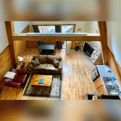 an overhead view of a living room with a fireplace at A-Frame #09 - by The Chalets in Logan