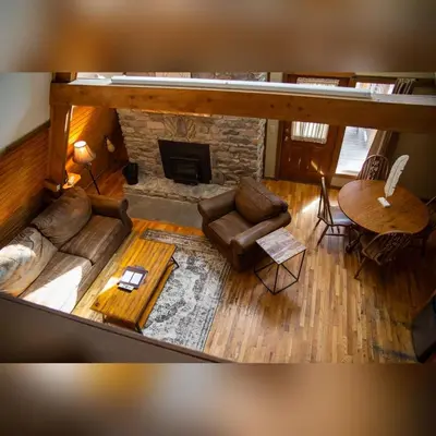 an overhead view of a living room with a fireplace at A-Frame #14 - by The Chalets in Logan