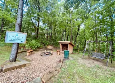 a park with a playground and a swing and a sign at A-Frame #16 - by The Chalets in Logan