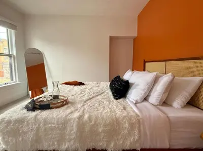 a bedroom with a large bed with a mirror on it at Jungle House Columbus Sleep 12 Downtown Ohio Free Parking - Near Convention Center & Nationwide Arena - 4BR Short North Luxury Home - Over 5,800 Five Star Stays in Columbus