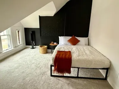 a bedroom with a bed with a black headboard at Jungle House Columbus Sleep 12 Downtown Ohio Free Parking - Near Convention Center & Nationwide Arena - 4BR Short North Luxury Home - Over 5,800 Five Star Stays in Columbus