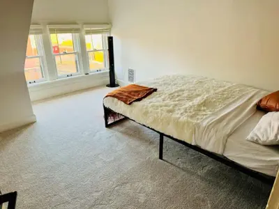a bedroom with a bed and two windows at Jungle House Columbus Sleep 12 Downtown Ohio Free Parking - Near Convention Center & Nationwide Arena - 4BR Short North Luxury Home - Over 5,800 Five Star Stays in Columbus