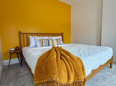 a bedroom with a bed with a blanket on it at Jungle House Columbus Short North Downtown Free Parking - Near Convention Center & Nationwide Arena - 4BR Luxury Home - Sleeps 12 - Over 5,800 Five Star Stays in Columbus