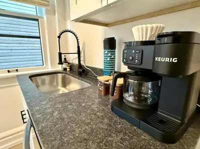a kitchen with a coffee maker on a counter at Jungle House Columbus Short North Downtown Free Parking - Near Convention Center & Nationwide Arena - 4BR Luxury Home - Sleeps 12 - Over 5,800 Five Star Stays in Columbus