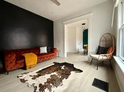 a living room with a couch and a rug at Jungle House Columbus Short North Downtown Free Parking - Near Convention Center & Nationwide Arena - 4BR Luxury Home - Sleeps 12 - Over 5,800 Five Star Stays in Columbus