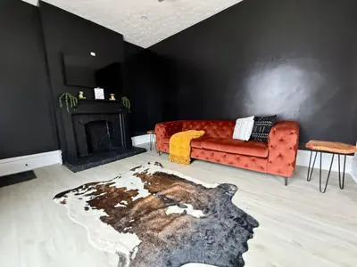 a living room with a red couch and a fireplace at Jungle House Columbus Short North Downtown Free Parking - Near Convention Center & Nationwide Arena - 4BR Luxury Home - Sleeps 12 - Over 5,800 Five Star Stays in Columbus