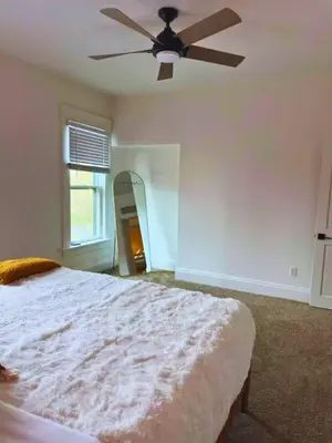 a bedroom with a bed and a ceiling fan at Jungle House Luxury Stays - Columbus Downtown Short North in Columbus