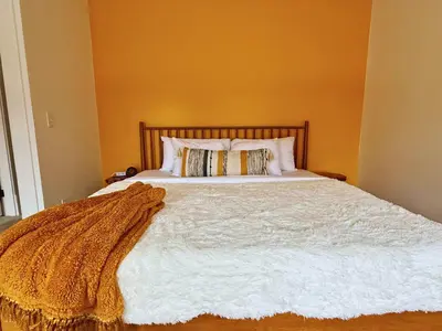 a bedroom with a bed with a blanket on it at Jungle House Luxury Stays - Columbus Downtown Short North in Columbus