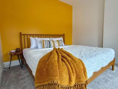 a bedroom with a bed with a blanket on it at Jungle House Luxury Stays - Columbus Downtown Short North in Columbus