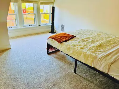 a bed in a room with a large window at Jungle House Luxury Stays - Columbus Downtown Short North in Columbus