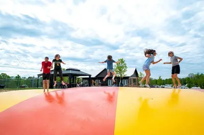 a group of children jumping on top of a ramp at Fantastic Secluded Tented Cabin with Fire Pit in Logan, Ohio in Logan