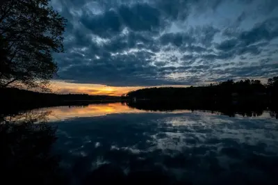 a view of a lake with a cloudy sky at Fantastic Secluded Tented Cabin with Fire Pit in Logan, Ohio in Logan