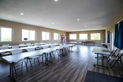 an empty room with tables and chairs in a classroom at Hocking Hills Deluxe Safari Glamping Tents in Logan