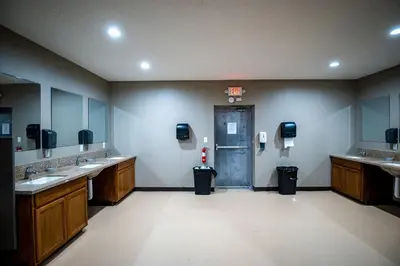a bathroom with two sinks and a door in a room at Hocking Hills Deluxe Safari Glamping Tents in Logan